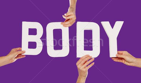 Female hands holding letters BODY Stock photo © stryjek