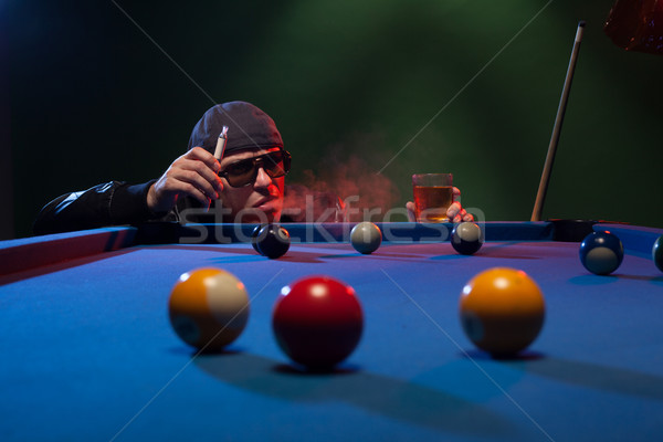 Man playing pool in a club smoking e-cigarette Stock photo © stryjek