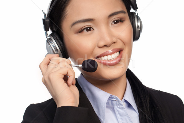 Smiling Asian call centre operator Stock photo © stryjek
