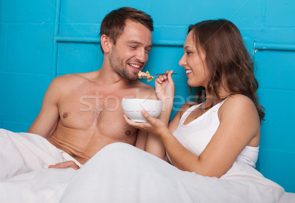 Wife feeding her husband breakfast in bed Stock photo © stryjek