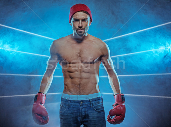 Young athletic boxer in a smoky background Stock photo © stryjek