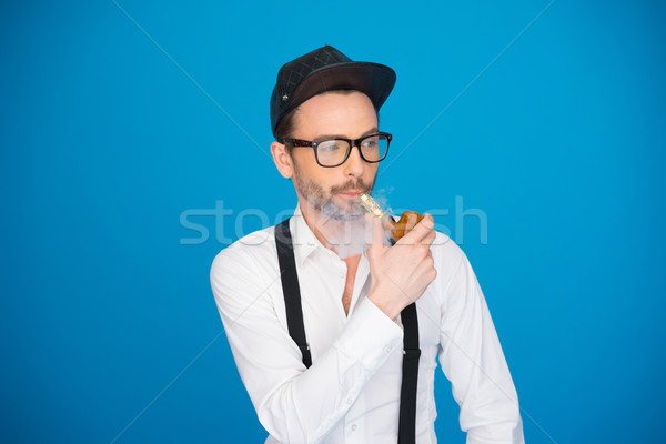 man wearing shirt and hat smoking e-pipe Stock photo © stryjek