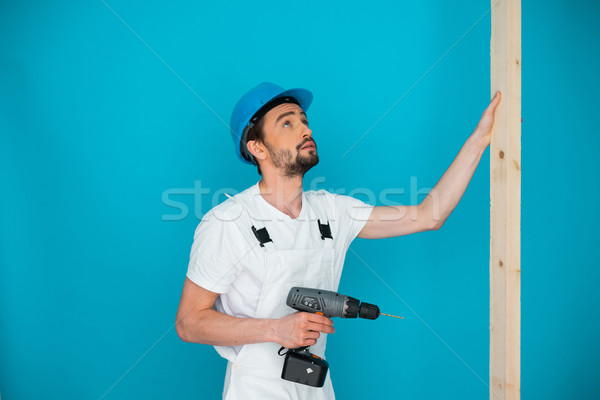Workman in a hardhat holding a drill Stock photo © stryjek