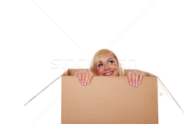 Smiling young blonde emerging from a box Stock photo © stryjek