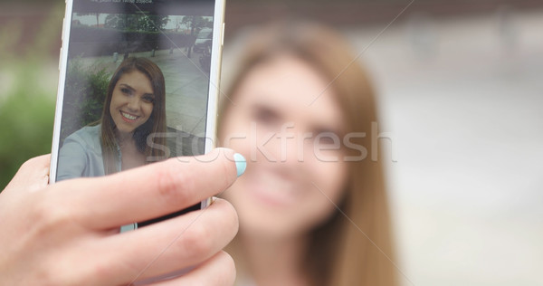 Young woman taking selfie on the street Stock photo © stryjek