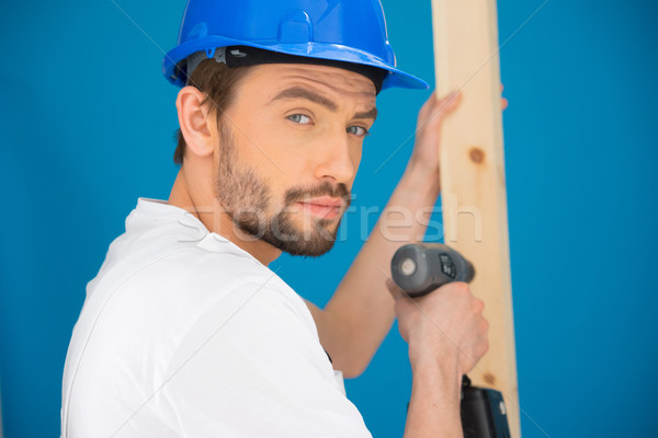 Builder using a drill looking at the camera Stock photo © stryjek