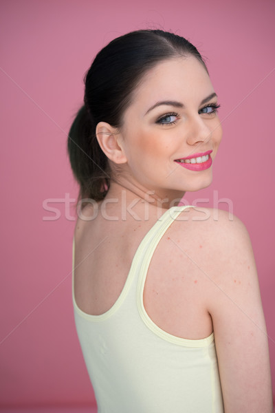 Felice donna sorridente guardando indietro spalla casuale Foto d'archivio © stryjek
