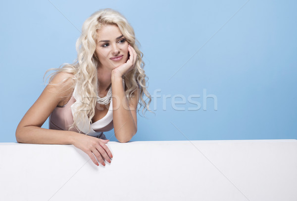 Stock photo: beauty, fashion and young woman in pink dress on blue background