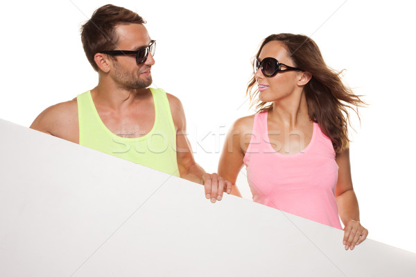 Casual couple in sunglasses with a blank sign Stock photo © stryjek