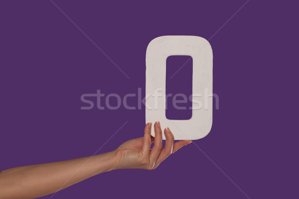 Female hand holding up the number 0 from the left Stock photo © stryjek
