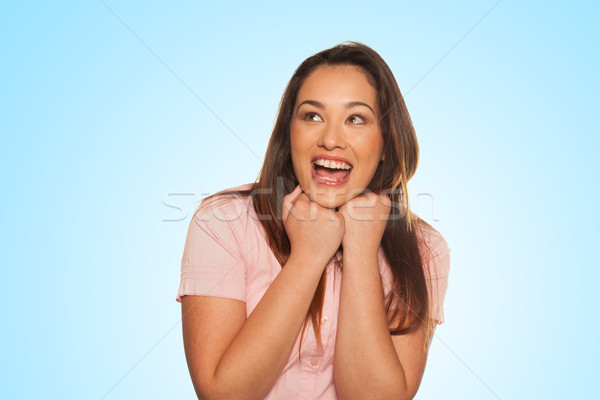 Smiling young woman expressing scare and surprise Stock photo © stryjek