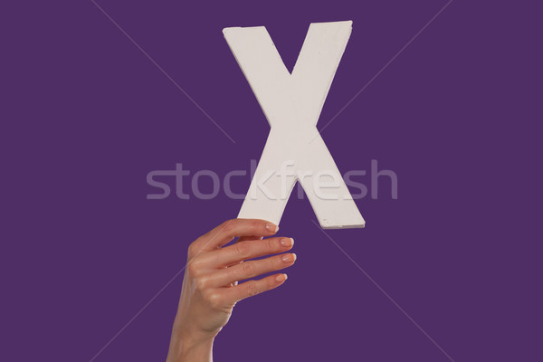 Female hand holding up the letter x from the bottom Stock photo © stryjek