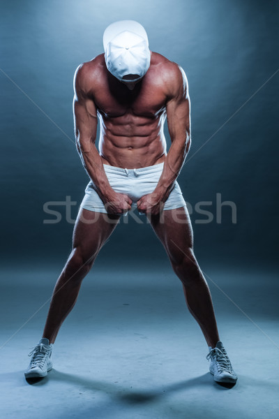Athletic Man in Mini Shorts and Cap Facing Down Stock photo © stryjek
