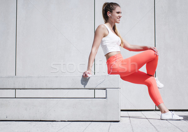 Pretty Woman in Sports Attire Sitting on the Bench Stock photo © stryjek
