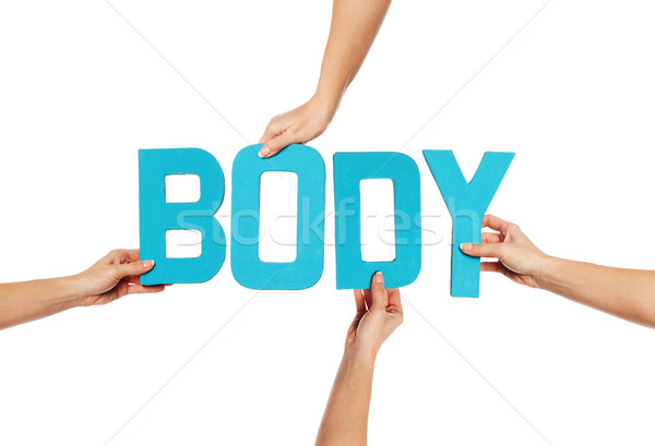 Stock photo: Female hands holding letters BODY