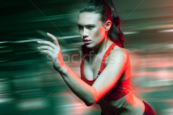 Female sprinter running at speed Stock photo © stryjek