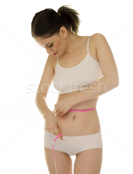 Slender young woman measuring her waist Stock photo © stryjek