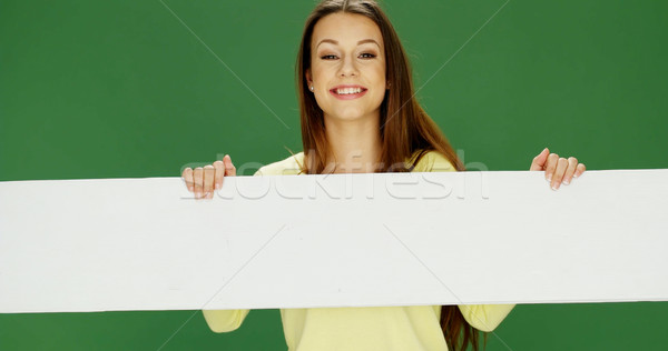 Stock photo: Smiling woman holding a long banner