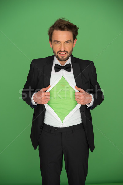 Man in a suit and bow tie revealing his chest Stock photo © stryjek
