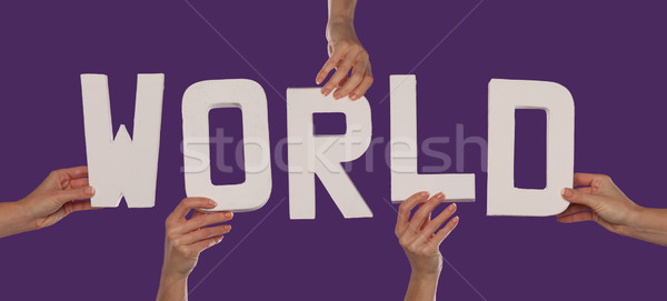 Stock photo: Lettering WORLD held in female hands