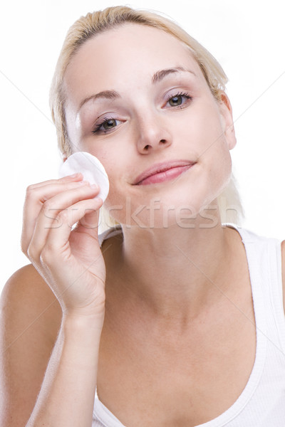 Beautiful blonde removing facial make-up Stock photo © stryjek