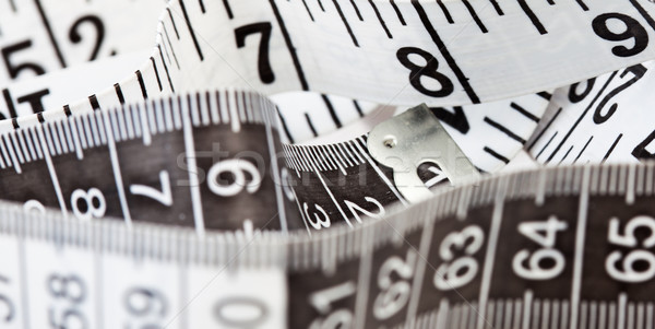 Measuring tape, symbol of tailoring and diets Stock photo © stryjek
