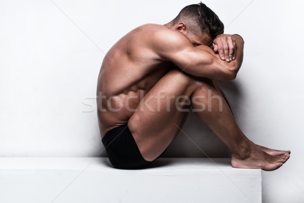 Muscular Man Sitting with Face Hidden Folded Arms Stock photo © stryjek