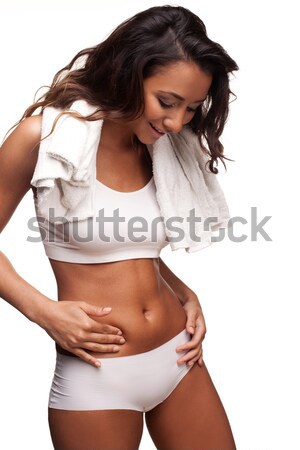 Beautiful tanned woman measuring her waist Stock photo © stryjek