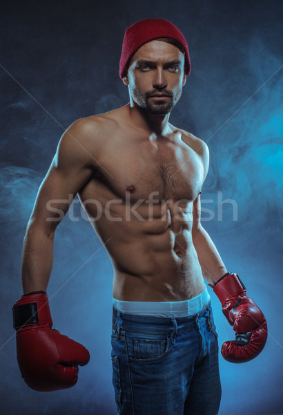 Young athletic boxer in a smoky background Stock photo © stryjek