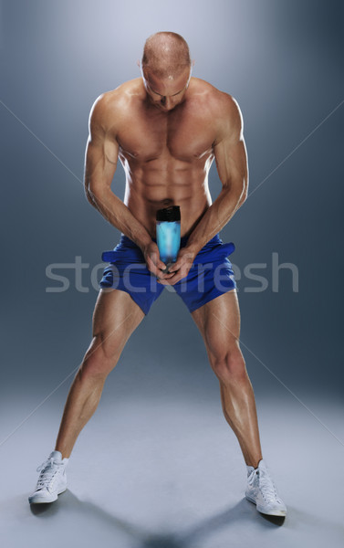 Torse nu athlétique jeune homme une bouteille d'eau [[stock_photo]] © stryjek
