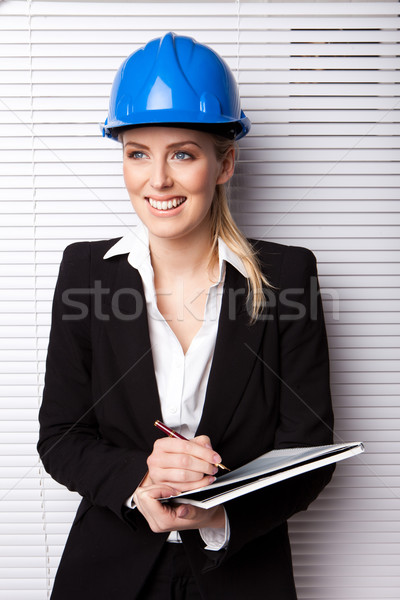 Mosolygó nő védősisak tart toll notebook üzlet Stock fotó © stryjek