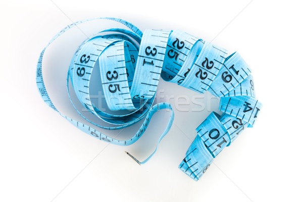 Blue measuring tape, shot from above, on white Stock photo © stryjek