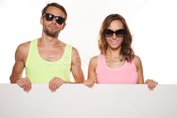happy couple holding a plain board Stock photo © stryjek