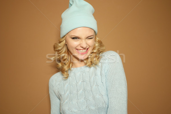 Gorgeous young woman with blond ringlets in a green knitted winter outfit Stock photo © stryjek