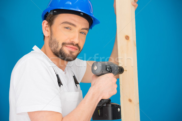 Builder using a drill looking at the camera Stock photo © stryjek