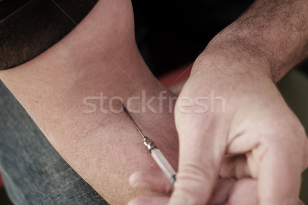 Man injecting himself with a small hypodermic Stock photo © stryjek