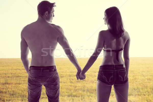 Romantic young couple holding hands Stock photo © stryjek