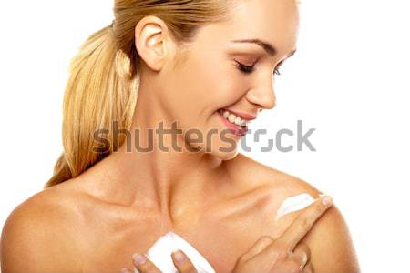 Gülümseyen kadın vücut krem aşağı bakıyor çıplak omuz Stok fotoğraf © stryjek