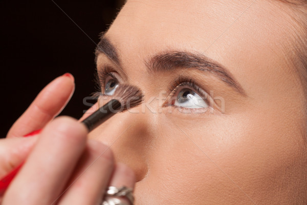 Beautician applying cosmetics on a young model Stock photo © stryjek