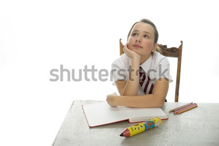 Young schoolgirl sitting doing her homework Stock photo © stryjek