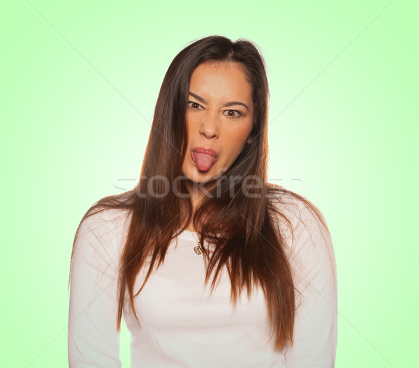 Young woman sticking the tongue out Stock photo © stryjek