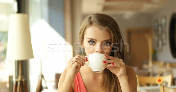 Young Woman Drinking Coffee in Sunny Cafe Stock photo © stryjek