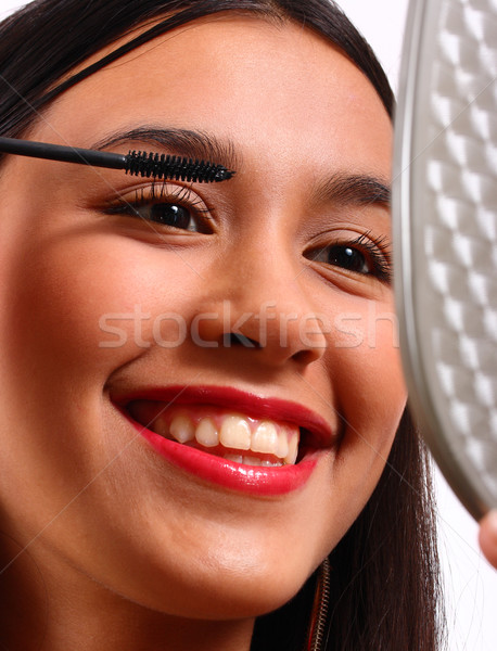 Happy Young Teenager Making Herself Up With Mascara Stock photo © stuartmiles