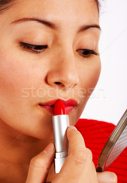 Mulher batom vermelho olhando pequeno espelho Foto stock © stuartmiles