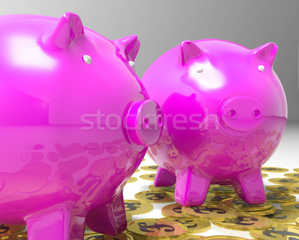 Piggybanks On Pound Coins Shows Britain Finances Stock photo © stuartmiles