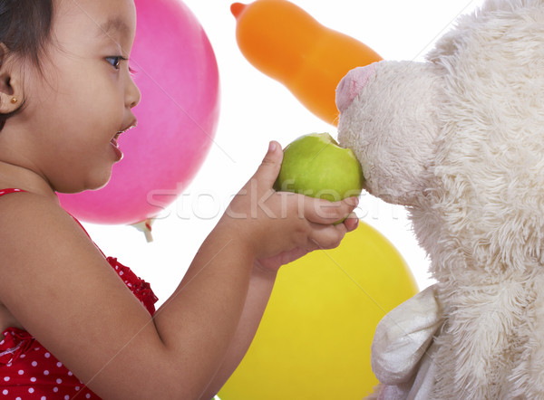 Kid Feeding Her Teddy An Apple Stock photo © stuartmiles