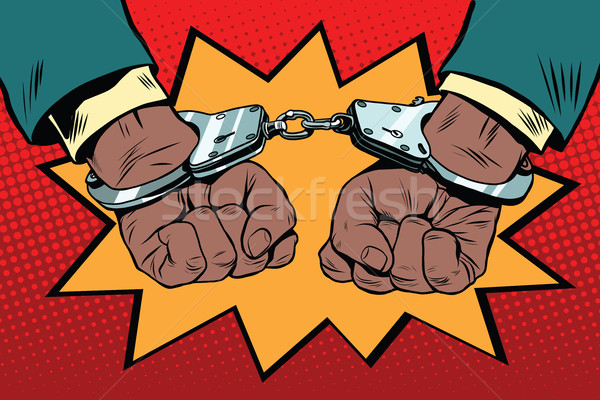 Stock photo: handcuffs behind the back, hands African American