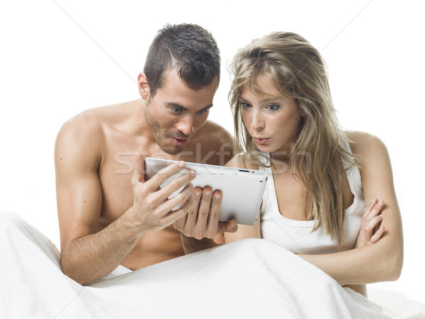 attractive couple watching things in a tablet Stock photo © Studiotrebuchet
