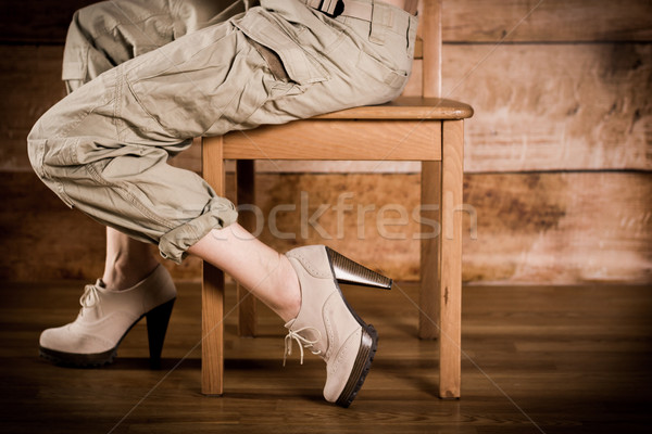 Girl sitting sideways on a chair Stock photo © superelaks