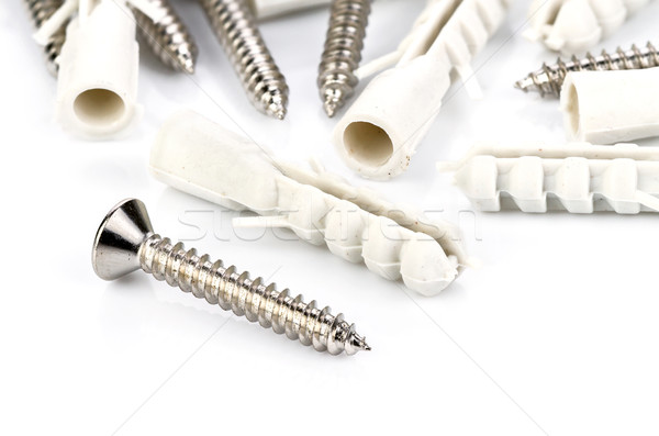 Stainless steel screw and plastic dowel on white Stock photo © supersaiyan3